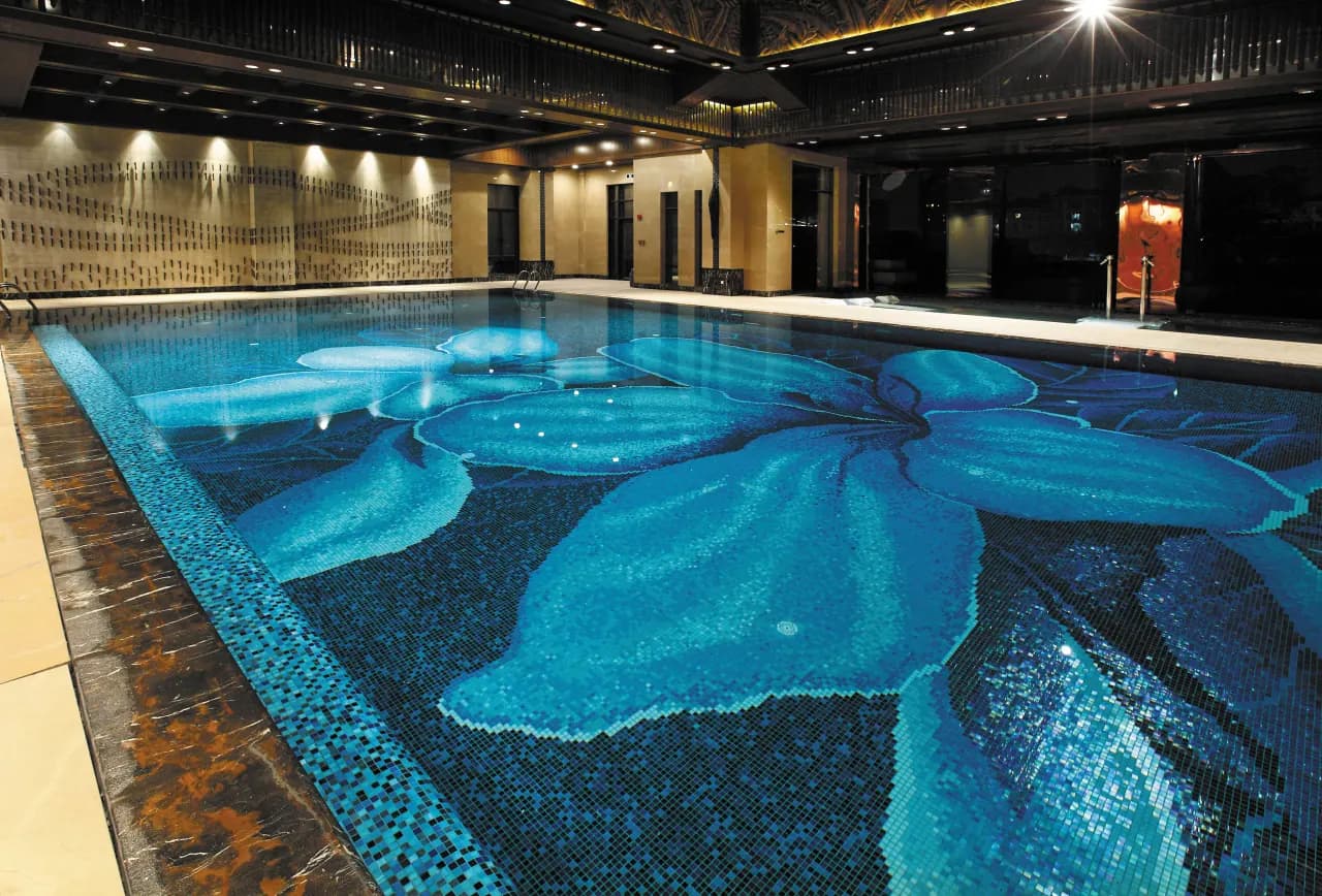 Mediterranean style outdoor pool with mosaic border