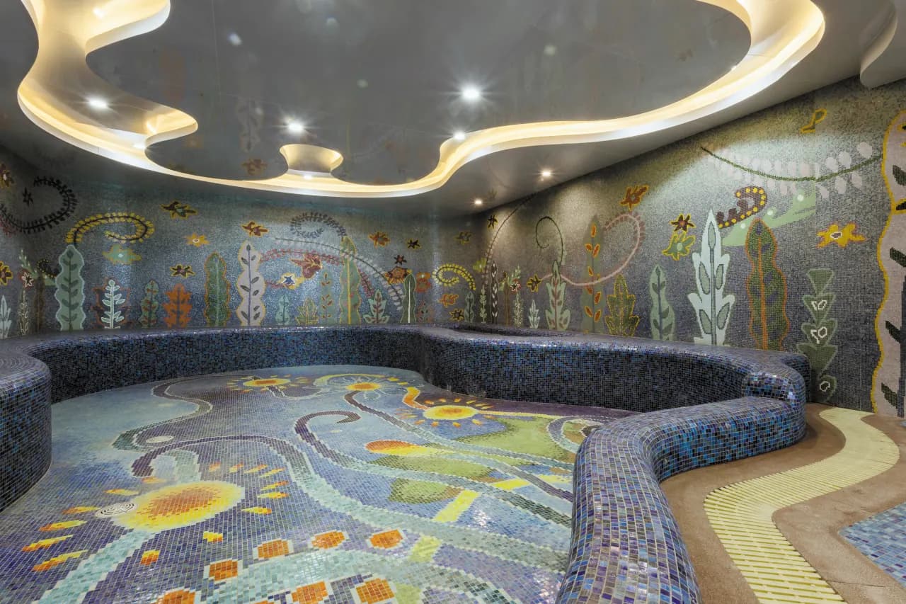 Resort infinity pool with ocean-inspired tiles