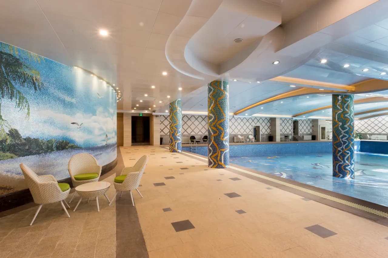 Beachfront infinity pool with glass mosaic tiles